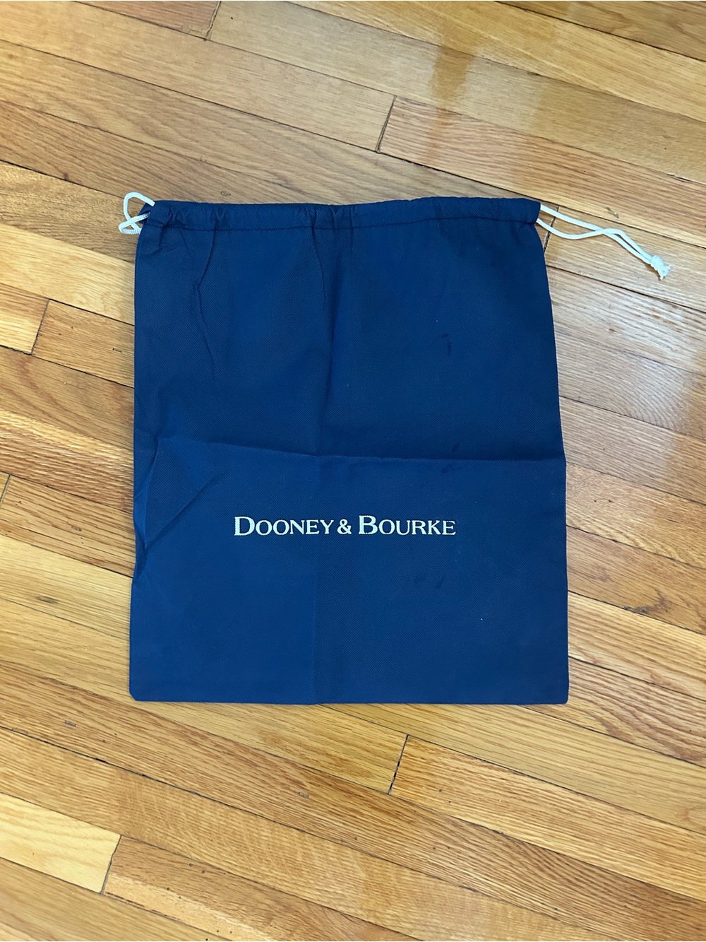 Dooney & Bourke Navy Duster bag with white Logo